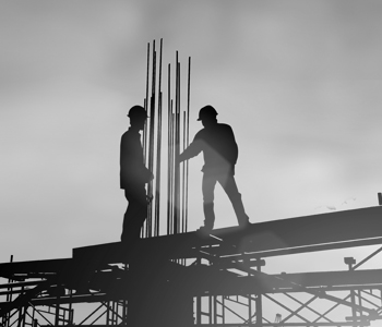 Two men standing confidently on a construction site